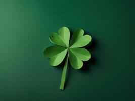 St Patrick Day concept Paper art and craft style four-leaf clover on green background Flat lay, top view, vertical. photo