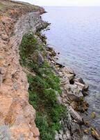 An impregnable precipitous rocky shore in the eastern Crimea photo