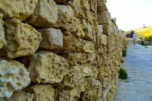 Weathering, erosion and destruction of limestone bricks of ancient structures on the island of Gozo, Malta photo
