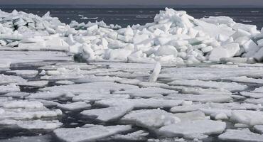 Ice Climatic collapse, heaps of ice blocks on the piers and the shore. The Black Sea near Odessa is frozen photo