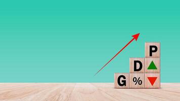 GDP business concept, Word GDP Gross domestic product on wooden block with up and down arrows with percentage icon. Business growth and measure for size of economy compiled for country. photo