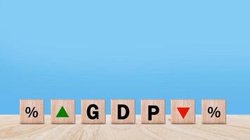 GDP business concept, Word GDP Gross domestic product on wooden block with up and down arrows with percentage icon. Business growth and measure for size of economy compiled for country. photo