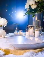 Elegant White Marble Pedestal with Candles and Flowers photo