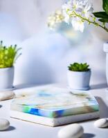 White Hexagonal Resin Display Stand with Blurred Flowers photo