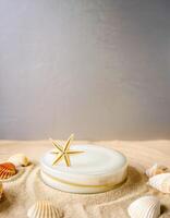 Seashells on a Sandy Background with a White Disk and Starfish photo