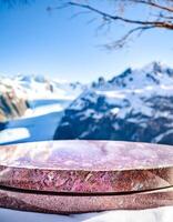 Stone platform overlooking a snowy mountain range photo