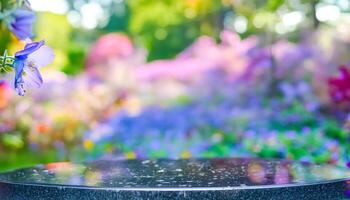 Closeup of a Black Tabletop with a Blurred Background of Colorful Flowers photo