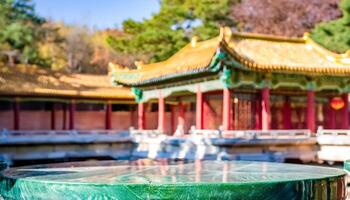 Green Jade Table with Blurred Chinese Architecture in Background photo