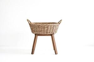 Wicker Basket with Wooden Legs on White Background photo