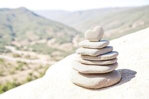 Stacked Rocks with Heart Shaped Stone on Top photo