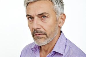 Close-up portrait of a thoughtful mature man with gray hair and beard photo