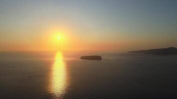 Sunset in Santorini Caldera - Aerial view at sunset of the volcano coasts of Santorini island in Greece video