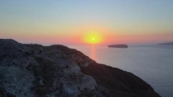 Sunset in Santorini Caldera - Aerial view at sunset of the volcano coasts of Santorini island in Greece video