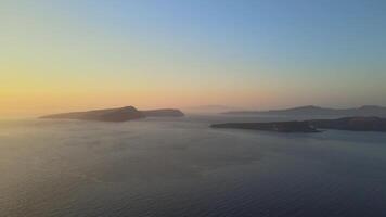Sunset in Santorini Caldera - Aerial view at sunset of the volcano coasts of Santorini island in Greece video