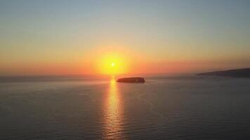 Sunset in Santorini Caldera - Aerial view at sunset of the volcano coasts of Santorini island in Greece video