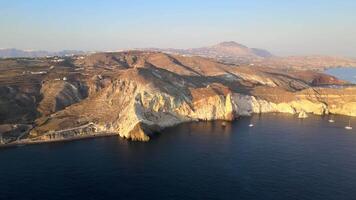 Sunset in Santorini Caldera - Aerial view at sunset of the volcano coasts of Santorini island in Greece video