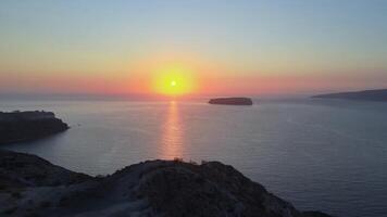 Sunset in Santorini Caldera - Aerial view at sunset of the volcano coasts of Santorini island in Greece video