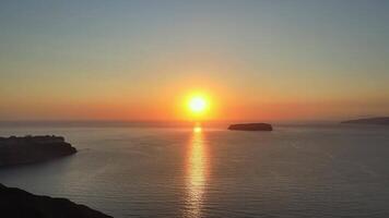 Sunset in Santorini Caldera - Aerial view at sunset of the volcano coasts of Santorini island in Greece video