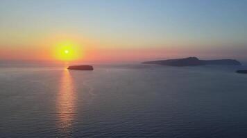 Sunset in Santorini Caldera - Aerial view at sunset of the volcano coasts of Santorini island in Greece video