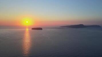 Sunset in Santorini Caldera - Aerial view at sunset of the volcano coasts of Santorini island in Greece video