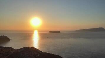 Sunset in Santorini Caldera - Aerial view at sunset of the volcano coasts of Santorini island in Greece video
