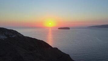 Sunset in Santorini Caldera - Aerial view at sunset of the volcano coasts of Santorini island in Greece video