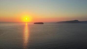 Sunset in Santorini Caldera - Aerial view at sunset of the volcano coasts of Santorini island in Greece video