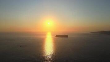 Sunset in Santorini Caldera - Aerial view at sunset of the volcano coasts of Santorini island in Greece video