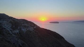 Sunset in Santorini Caldera - Aerial view at sunset of the volcano coasts of Santorini island in Greece video