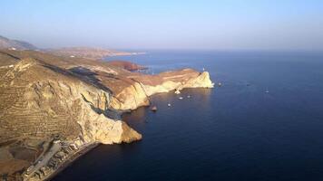 Sunset in Santorini Caldera - Aerial view at sunset of the volcano coasts of Santorini island in Greece video