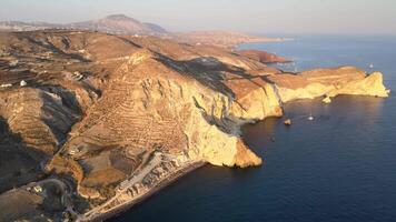 Sunset in Santorini Caldera - Aerial view at sunset of the volcano coasts of Santorini island in Greece video