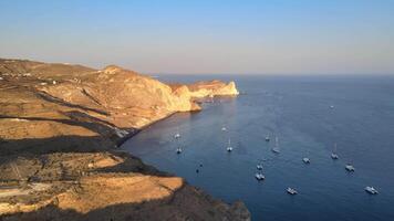 Sunset in Santorini Caldera - Aerial view at sunset of the volcano coasts of Santorini island in Greece video