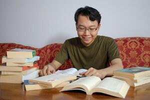 Asian young student study, reading and writing sit on sofa at living room. Isolated white background photo