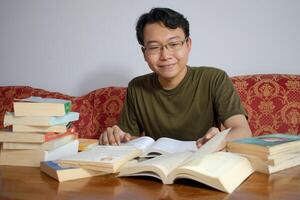 Asian young student study, reading and writing sit on sofa at living room. Isolated white background photo