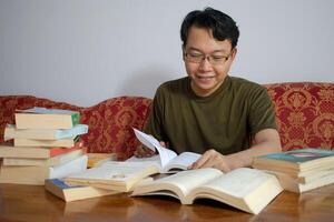 Asian young student study, reading and writing sit on sofa at living room. Isolated white background photo
