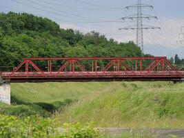 a red bridge over a river photo