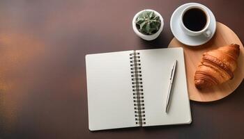 Open notebook with empty page and coffee cup photo