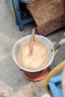 a typical food from betawi the province of DKI Jakarta, Indonesia made from eggs and sticky rice usually called kerak telor, being cooked in the traditional way photo