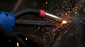 Detail of heavy industry manufacturing, sparks come out of a metal working welder. Closeup of a welding machine in work. Grinding a metal door in production. Grinding a steel structure photo