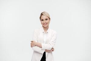 A middle-aged business woman in a white suit against studio background shows the emotions of a new idea. Business solutions concept. Banner advertising photo