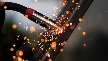 Detail of heavy industry manufacturing, sparks come out of a metal working welder. Closeup of a welding machine in work. Grinding a metal door in production. Grinding a steel structure photo