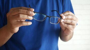 Individual Featuring a Pair of Glasses with Reflective Lenses while in an Indoor Environment video