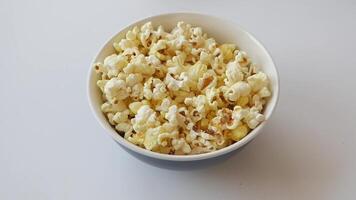 top view of child hand pick popcorn on white background video