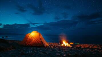 Camping on the beach at night with bonfire and tent. photo