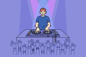 Man DJ performs in nightclub spinning records on mixing console, near partygoers hands vector