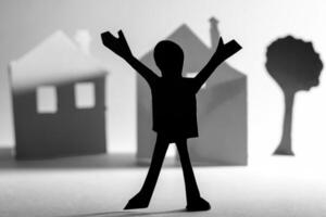 Cut from a paper person on the background of houses. photo