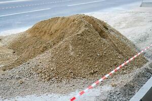 A pile of gray gravel. Repair of roads in the city. photo