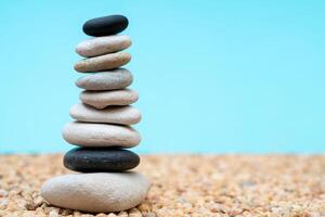 Stack of pebbles in an unstable state. A pyramid made of flat stones. photo