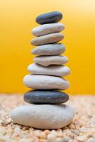 Stack of pebbles in an unstable state. A pyramid made of flat stones. photo