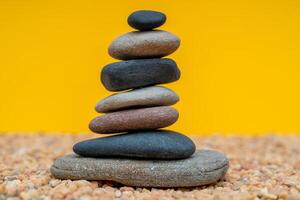 Stack of pebbles in an unstable state. A pyramid made of flat stones. photo